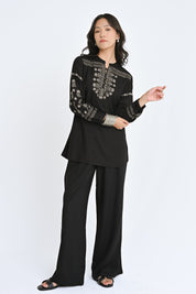 indigrey black straight-fit top with intricate latticework embroidery, floral details, and long sleeves on a model