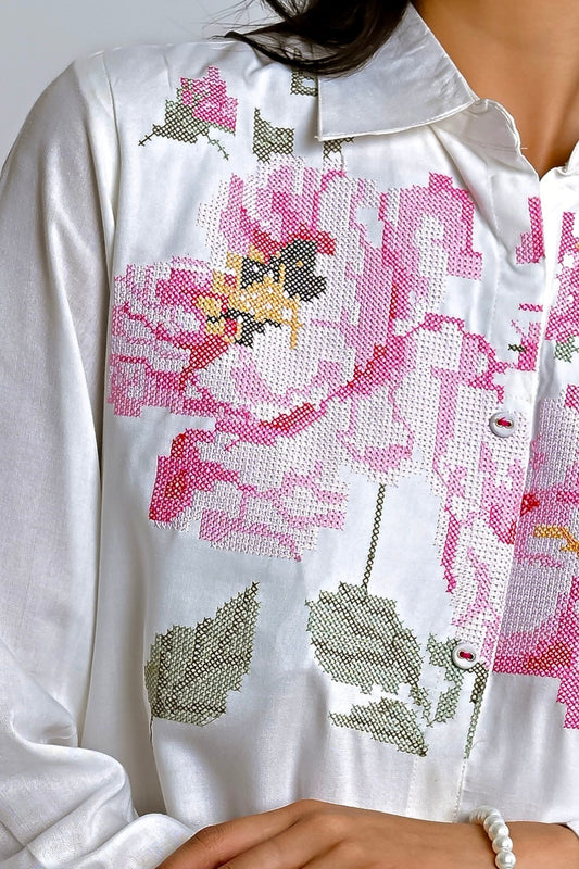indigrey white shirt featuring detailed pink and green floral pixel cross stitch embroidery on the front