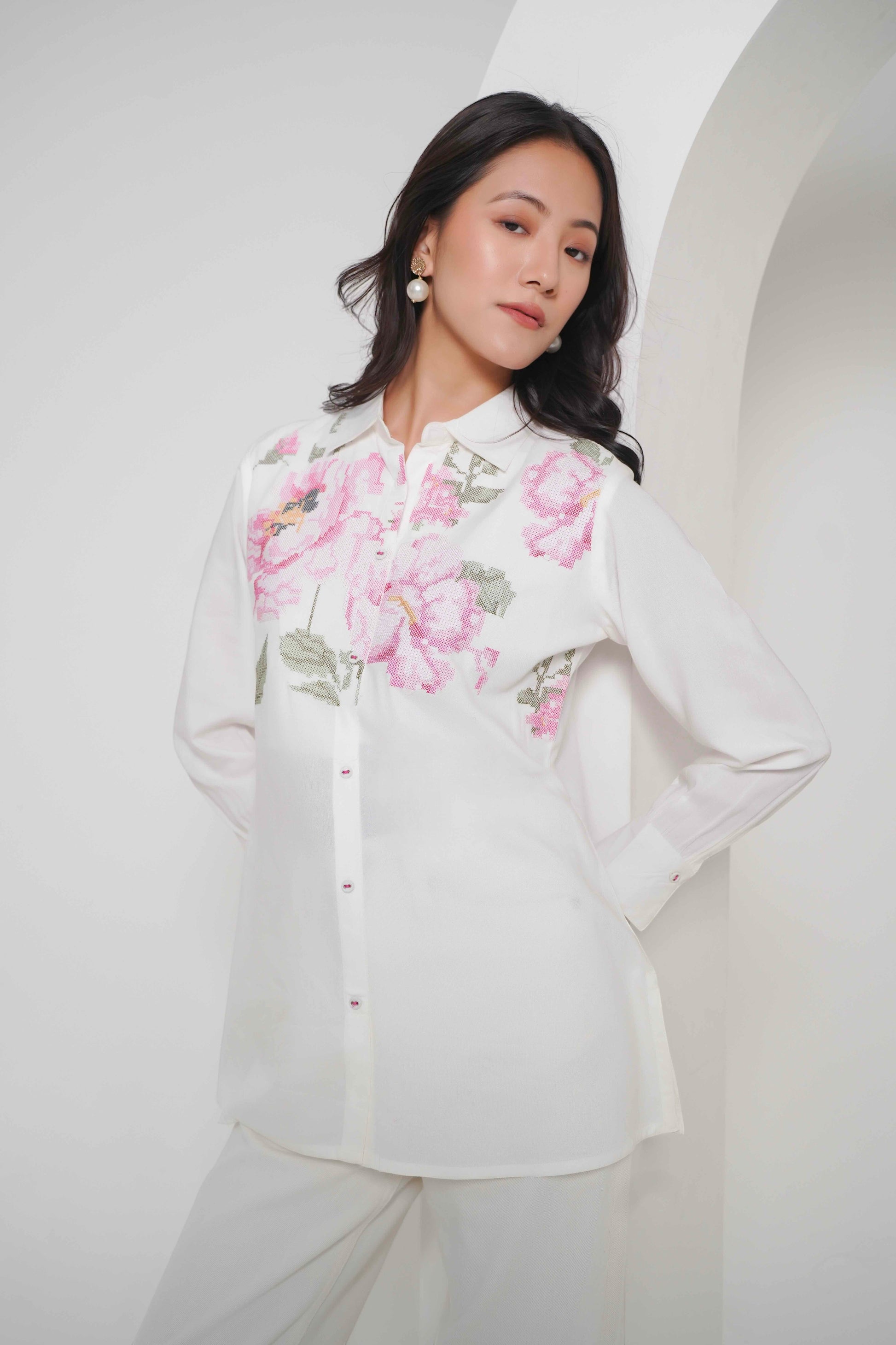 indigrey Ambrosia white shirt featuring intricate pink and green pixel cross stitch floral embroidery