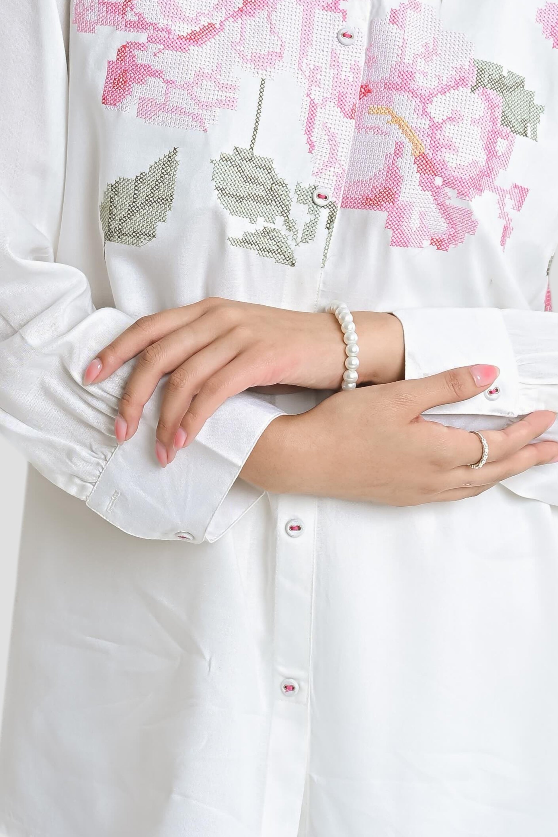 indigrey Ambrosia white shirt featuring intricate pink and green pixel cross stitch floral embroidery