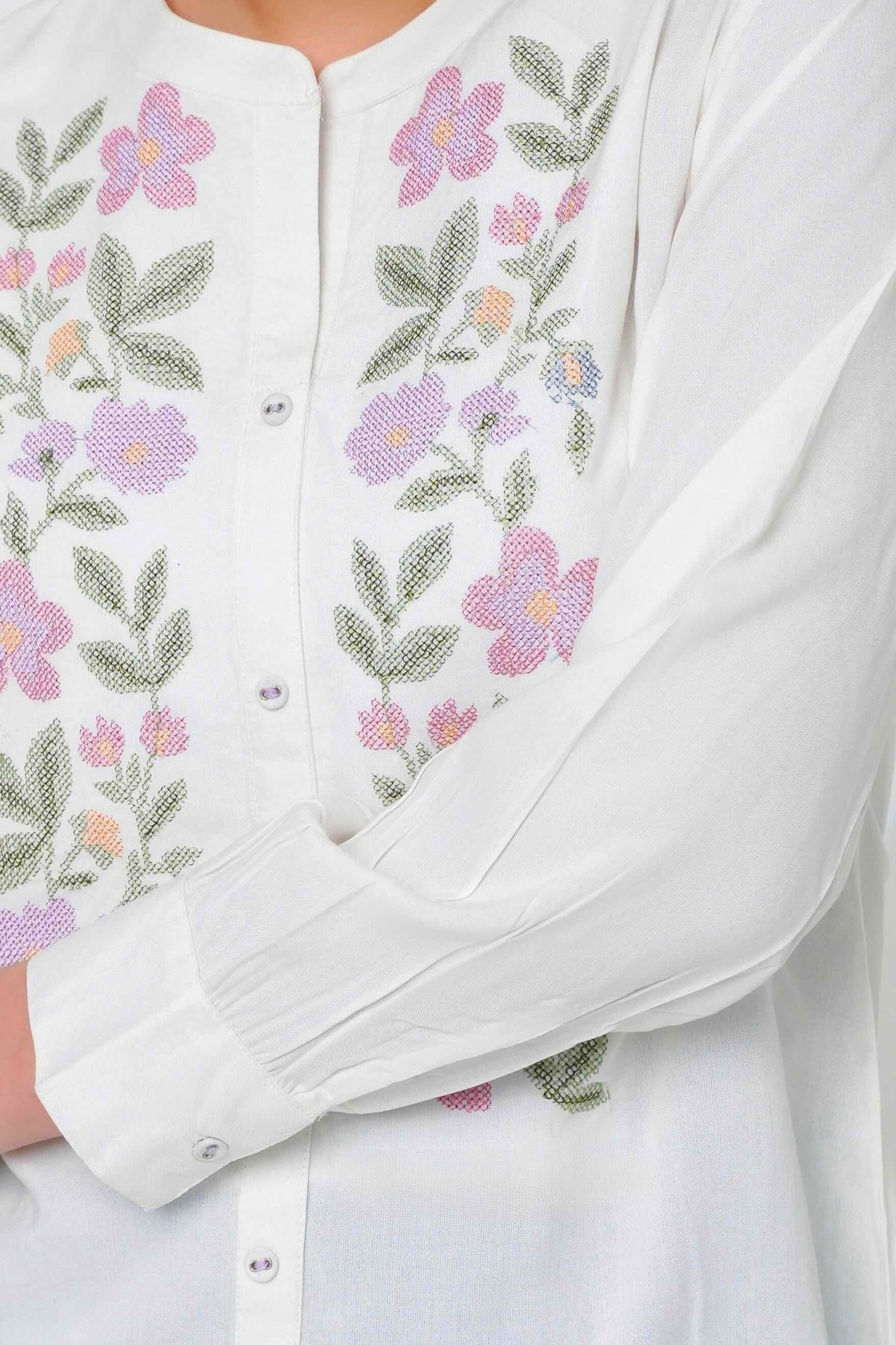 indigrey Aurora white shirt featuring delicate floral cross-stitch embroidery worn by a model with blue jeans.