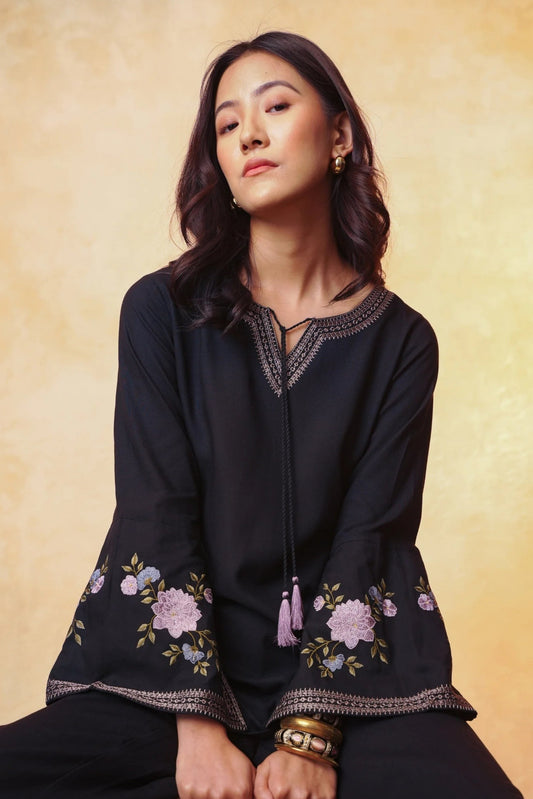 indigrey Zuri black viscose top with floral Sketchfill Cord embroidery and flared bell sleeves featuring tassels.