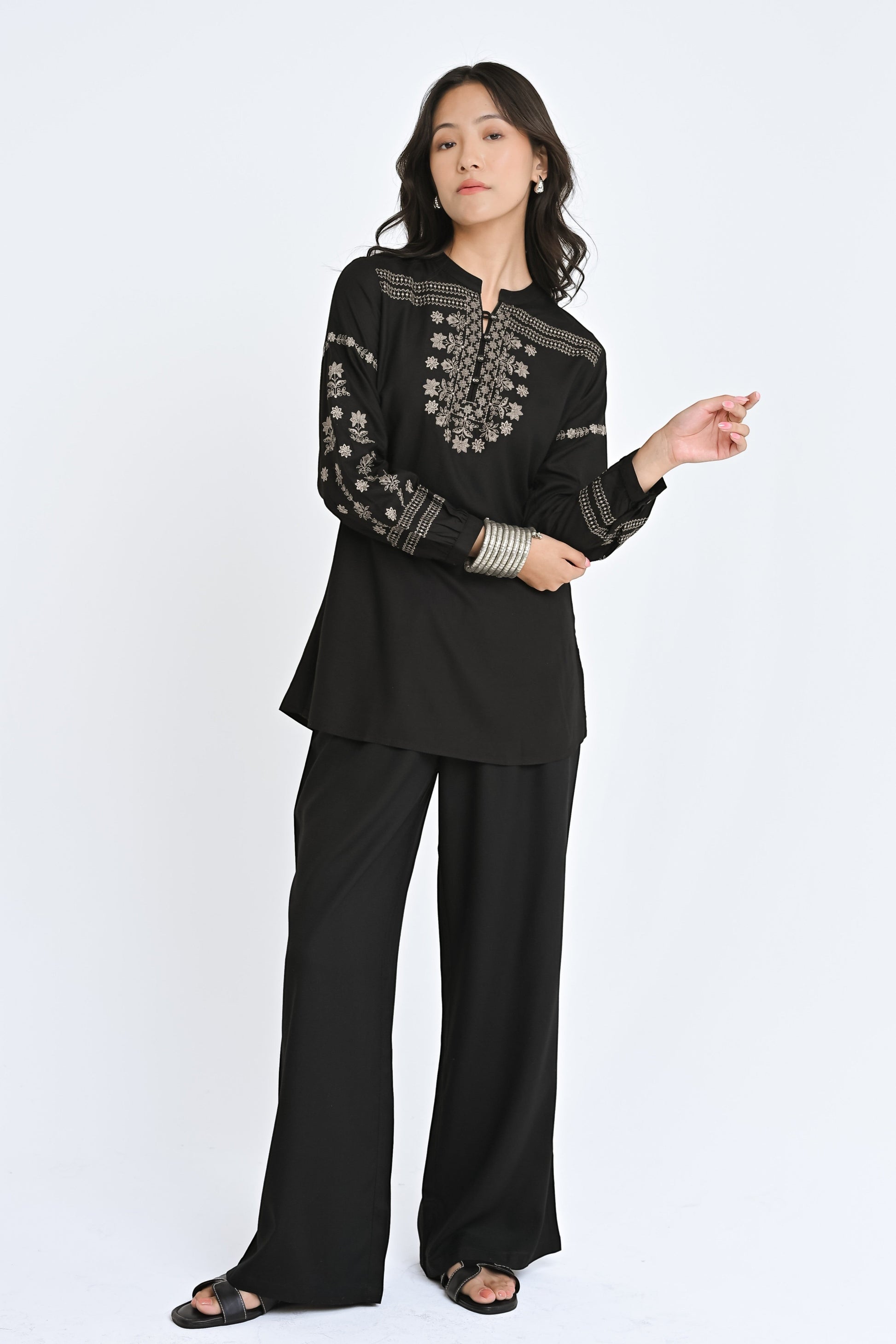 indigrey black straight-fit top with intricate latticework embroidery, floral details, and long sleeves on a model