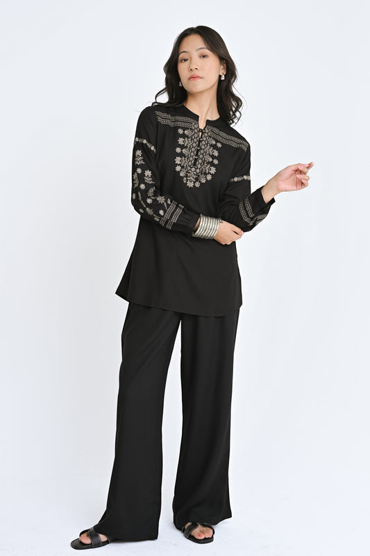 indigrey black straight-fit top with intricate latticework embroidery, floral details, and long sleeves on a model
