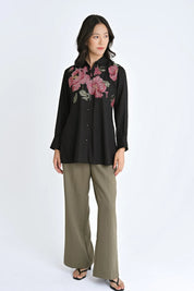 indigrey black shirt with floral pixel cross stitch embroidery worn by a model with olive wide-leg trousers