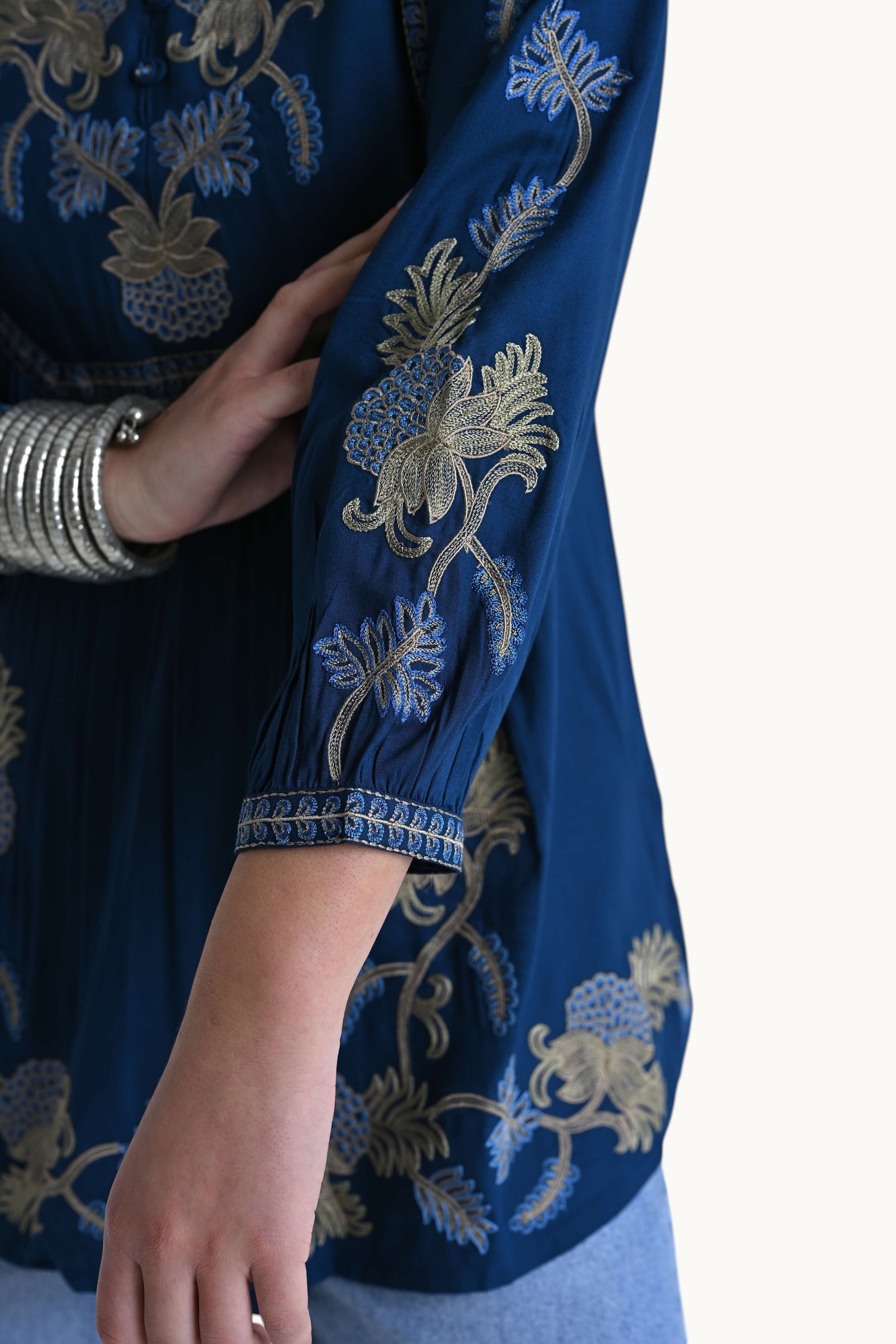 indigrey Dahlia teal top featuring intricate gold and blue pebblework embroidery on sleeves and bodice