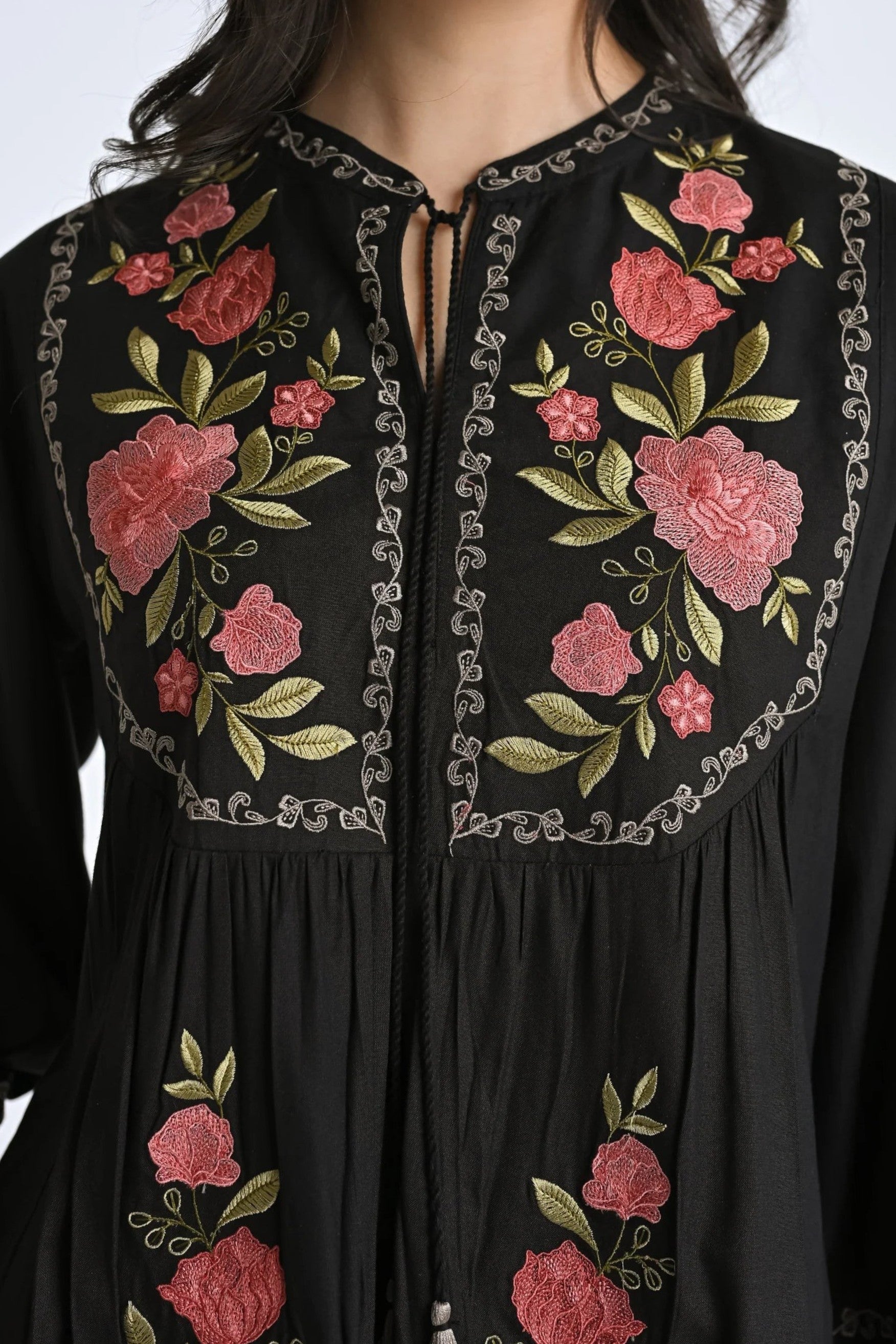 indigrey Goa black top featuring vibrant Tatami gradient floral embroidery, gathered fabric, and a tie-neck detail.