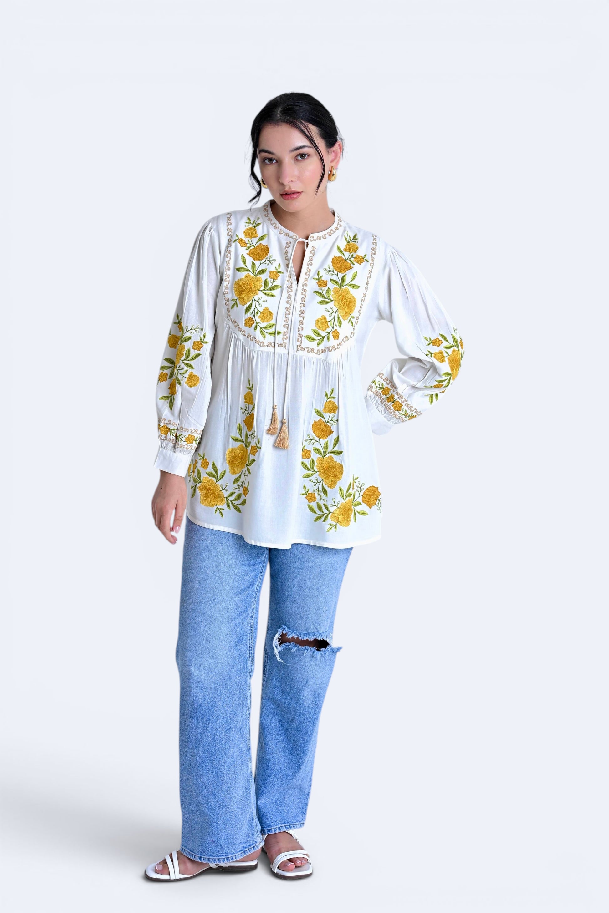 indigrey Goa white top with yellow floral Tatami gradient embroidery on yoke and sleeves, worn with ripped blue jeans