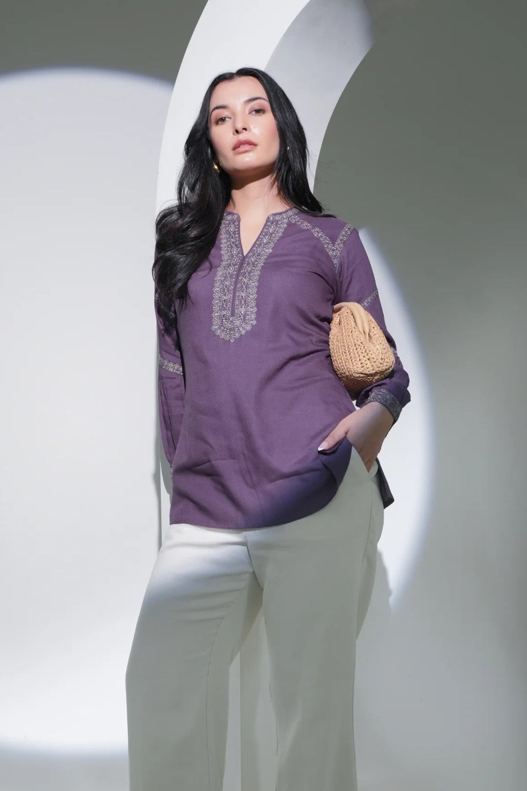 indigrey June purple top with intricate tonal filigree traceline embroidery worn by a model with cream trousers
