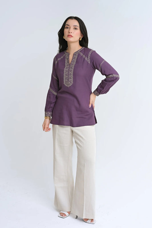 Model wearing an indigrey purple June top with intricate tonal floral Filigree Traceline embroidery and long sleeves.