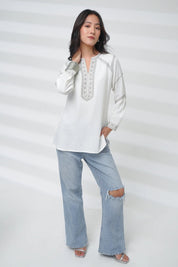 indigrey June white long-sleeve top with delicate grey filigree traceline embroidery worn by a model with jeans