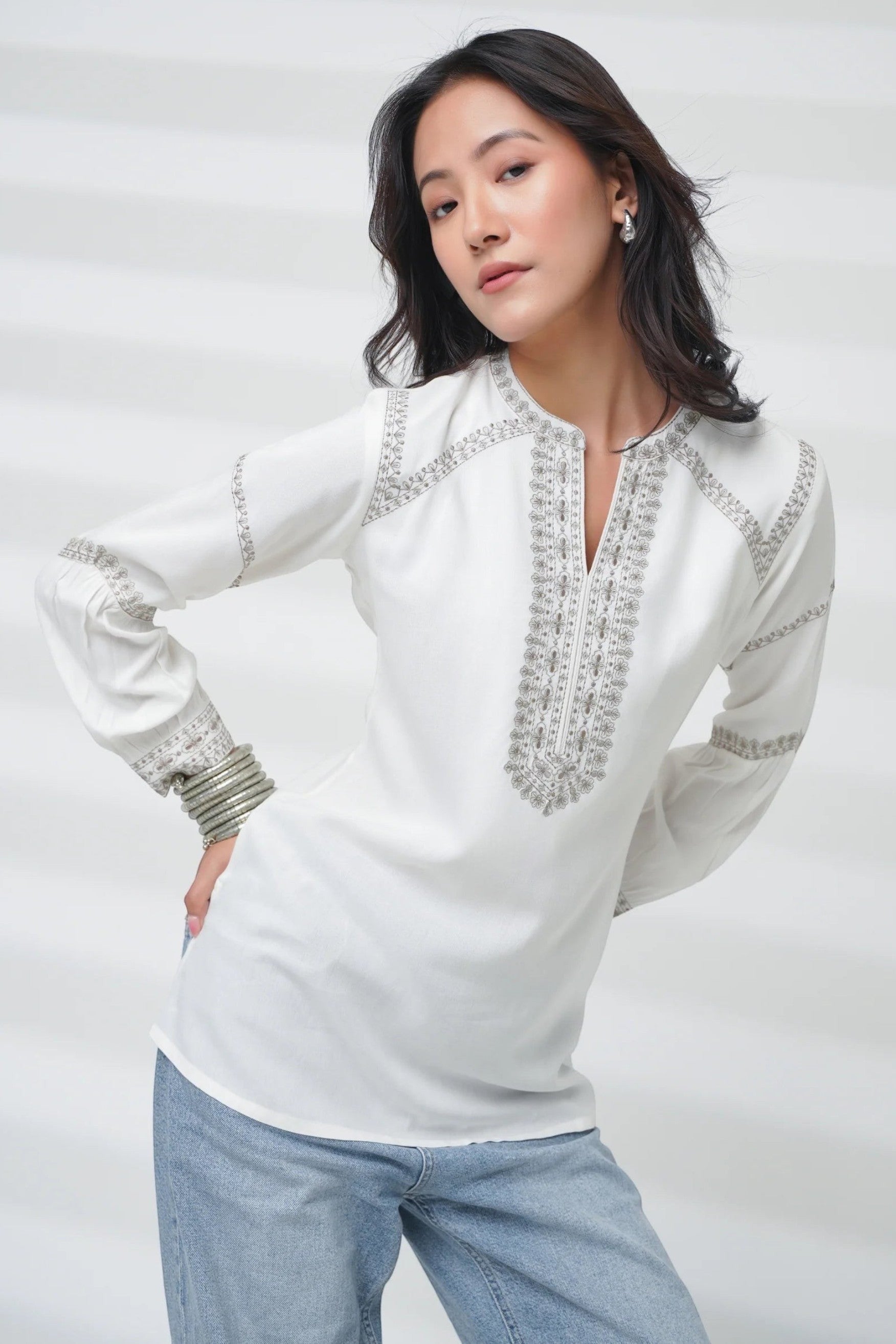 indigrey June white long-sleeve top featuring delicate grey filigree traceline embroidery on a model