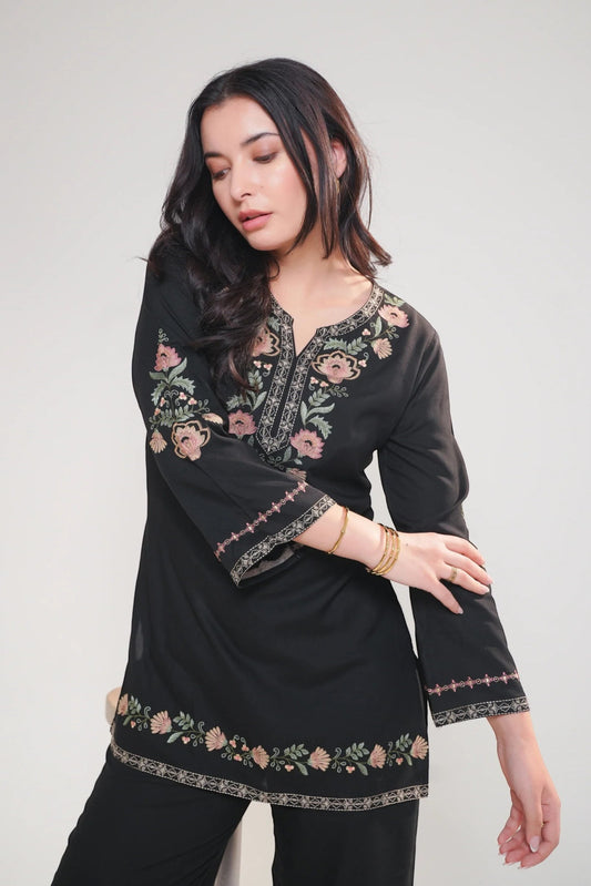 Model wearing a black indigrey Kaia co-ord set with Kashmiri-inspired floral stem threadfill embroidery.