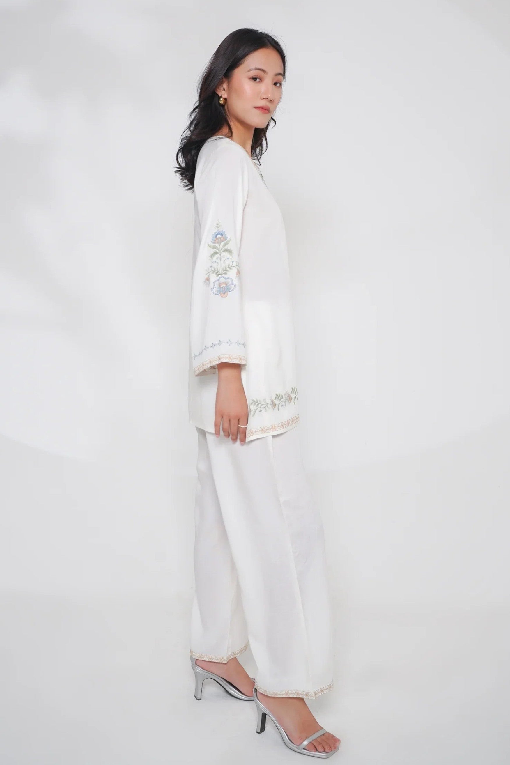 Model wearing indigrey white Kaia co-ord set with delicate Kashmiri-inspired stem threadfill floral embroidery.