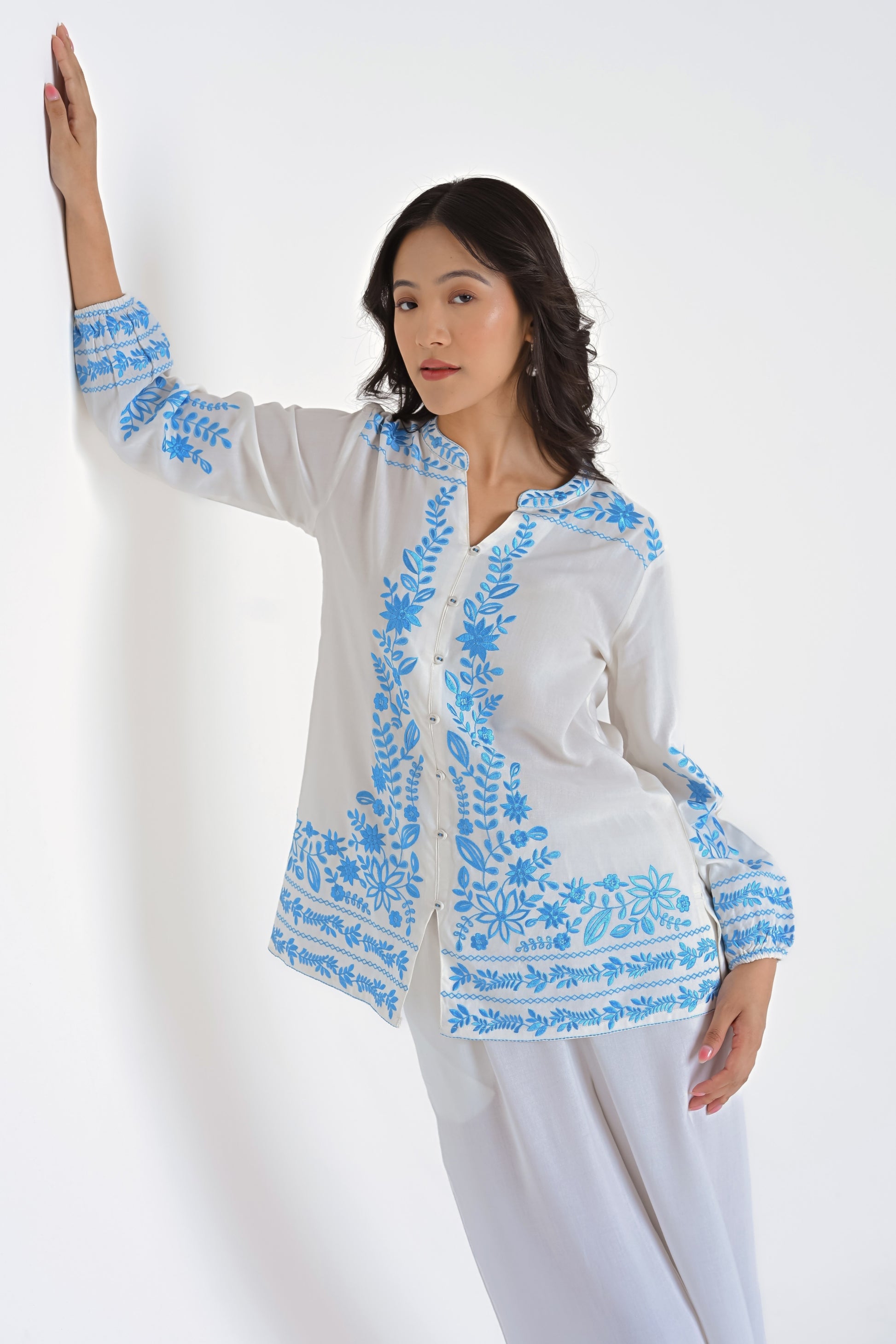 indigrey Luna white viscose shirt featuring intricate blue floral Tatami embroidery on the collar, sleeves, and hem.