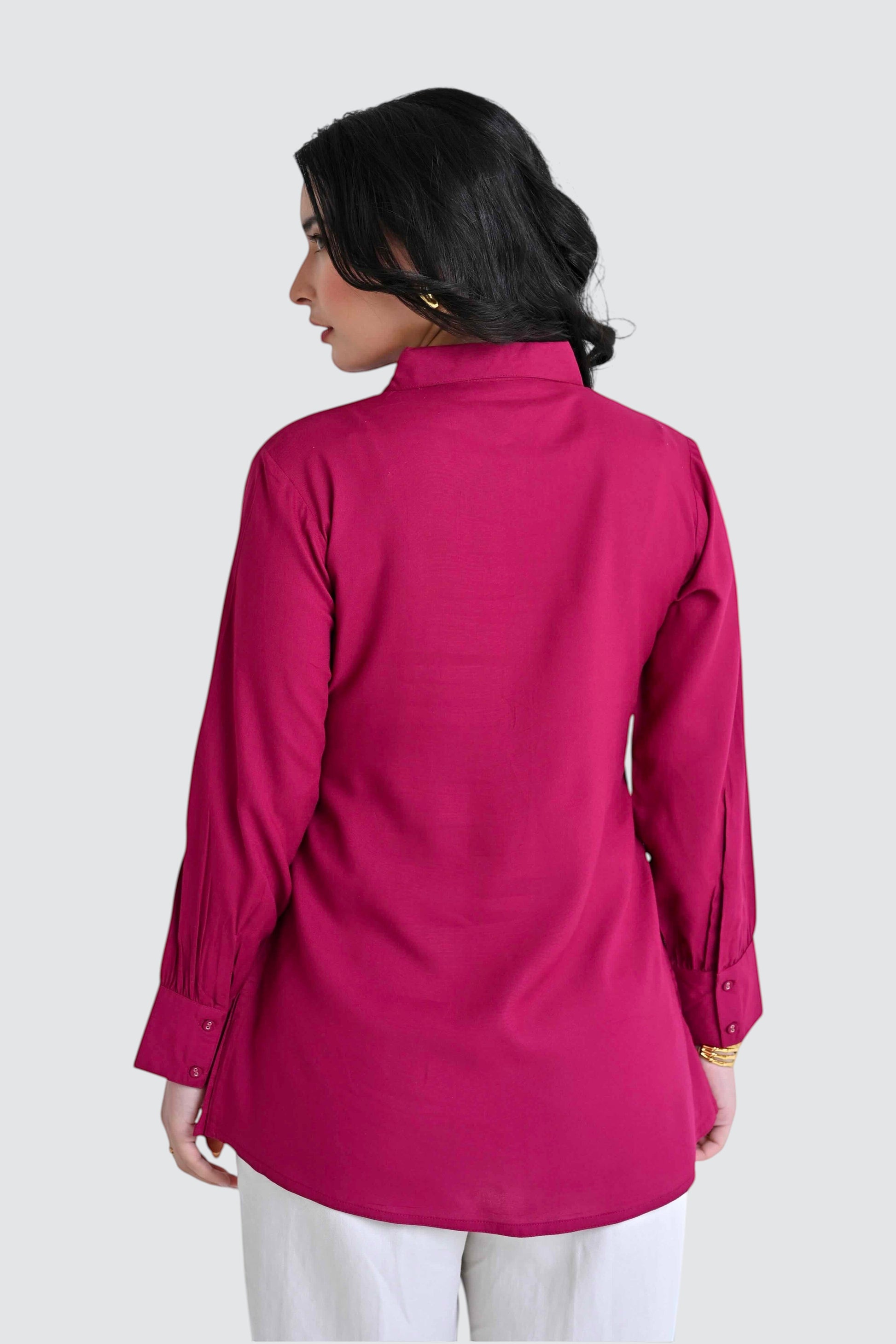 indigrey magenta long sleeve button down shirt worn by a woman, back view showing tailored cuffs and collar