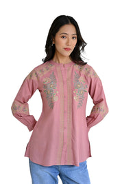 indigrey peach shirt with intricate floral chain tatami embroidery on shoulders and front, worn by a woman