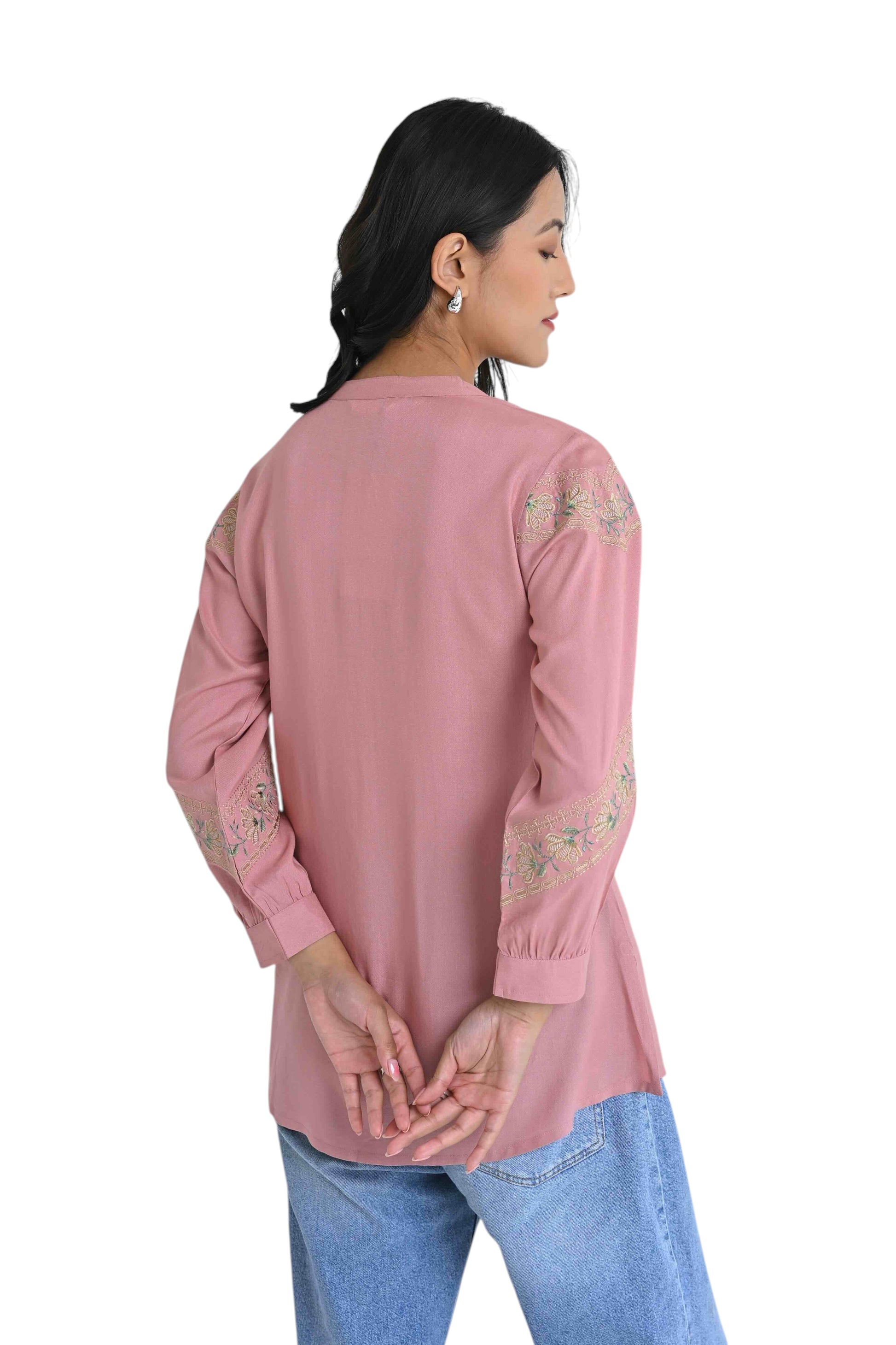indigrey peach shirt with earthy chain tatami embroidery on sleeves worn by a woman against a white background