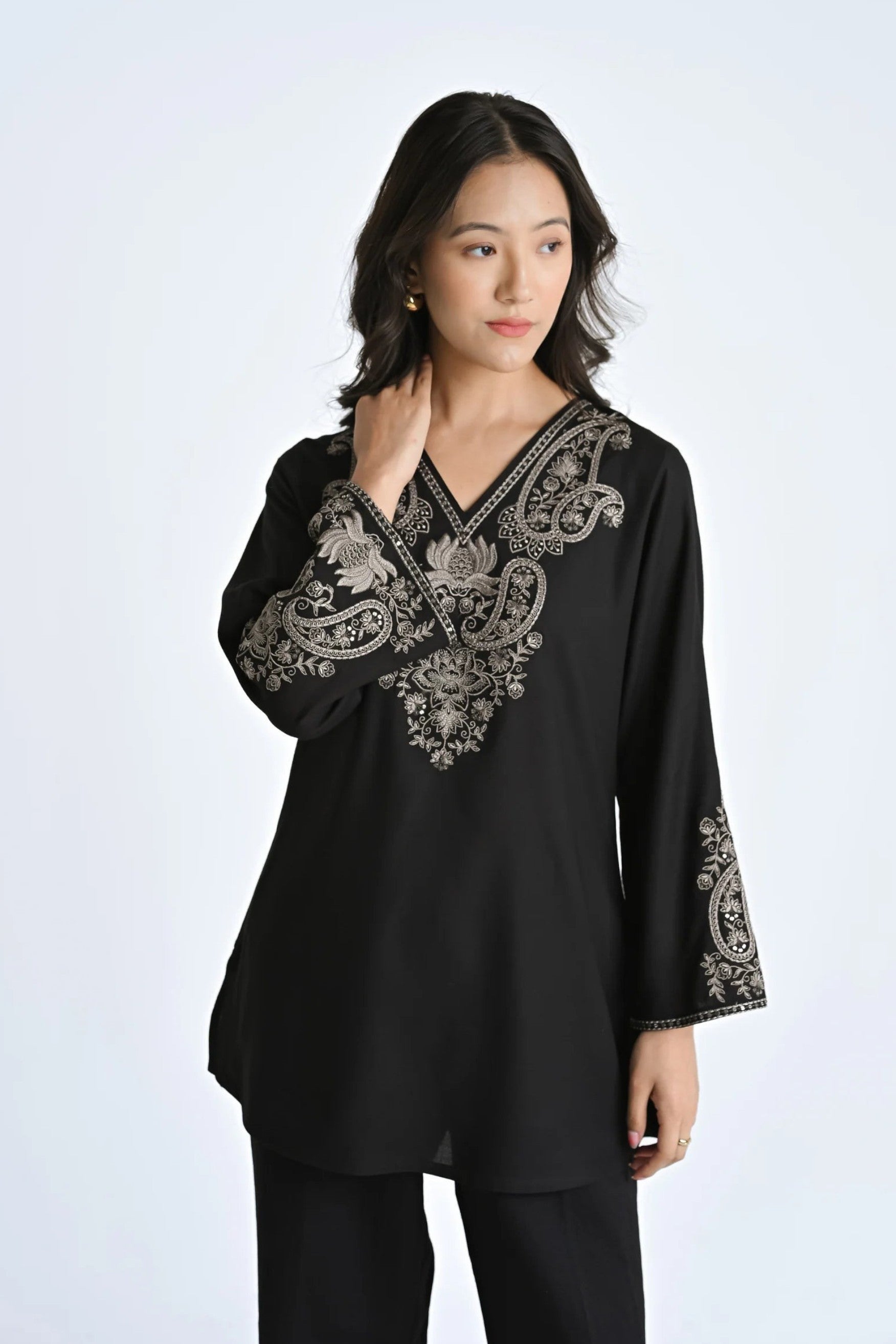 indigrey Raya black V-neck top featuring intricate corded stem fill embroidery on the neckline and flared sleeves.