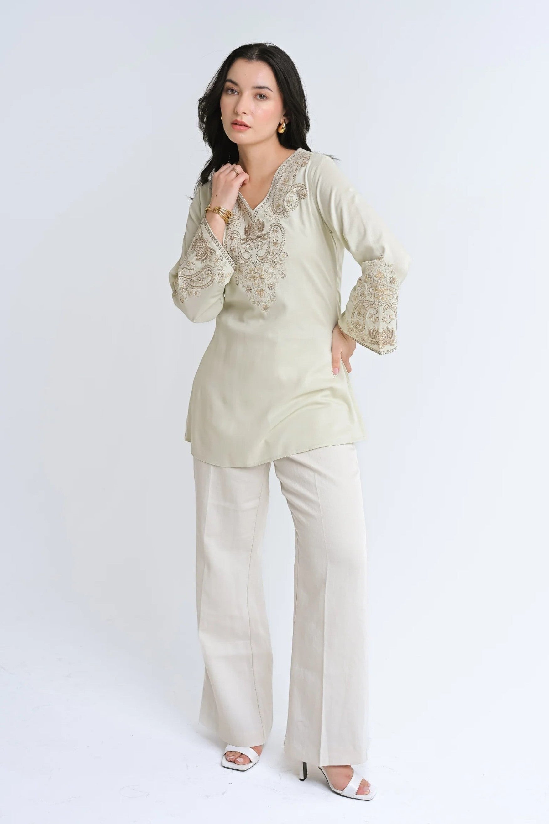 indigrey Raya ivory V-neck top with tonal corded stem fill embroidery and flared sleeves worn by a model