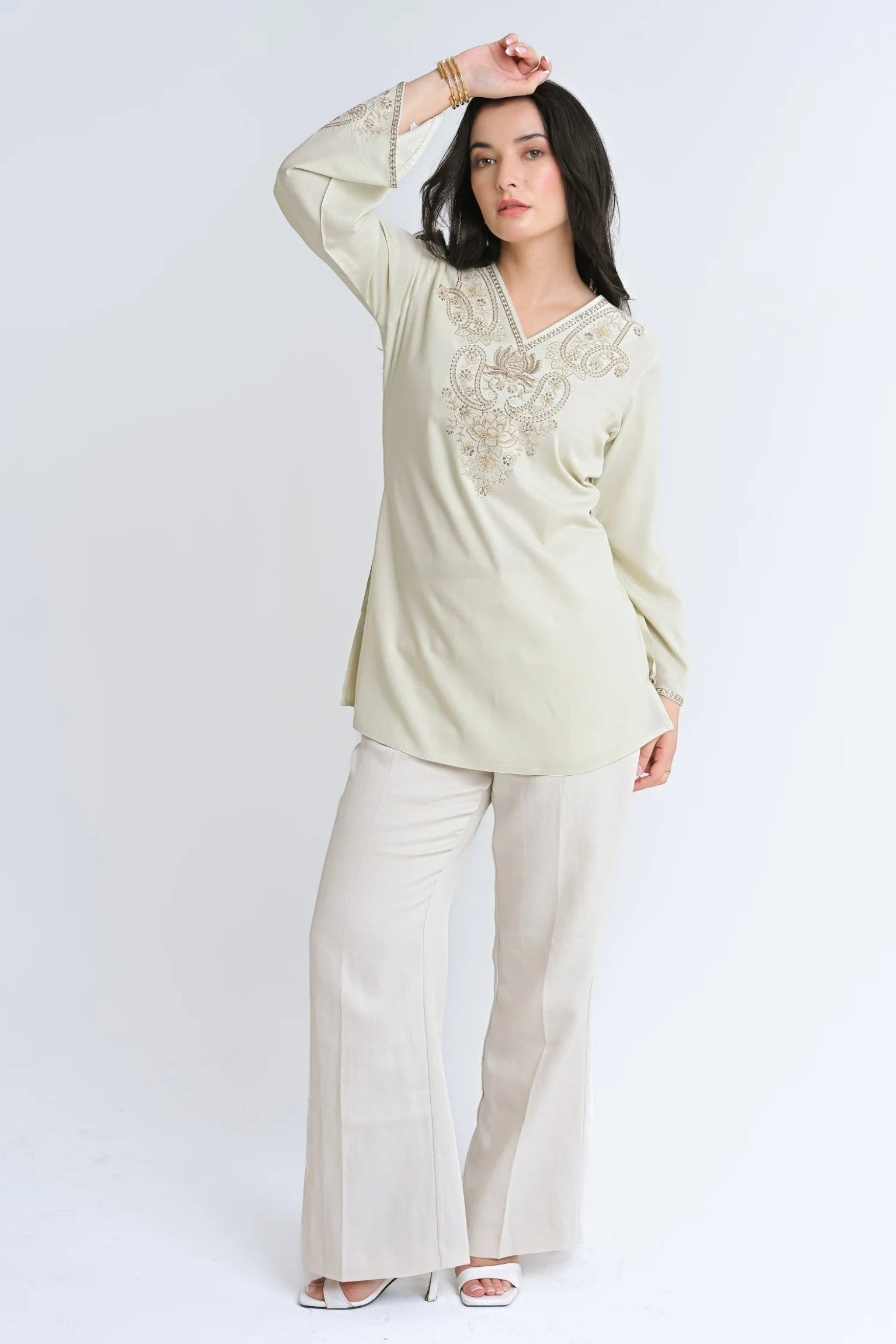 indigrey Raya ivory V-neck top with tonal corded stem fill embroidery and flared sleeves worn by a model