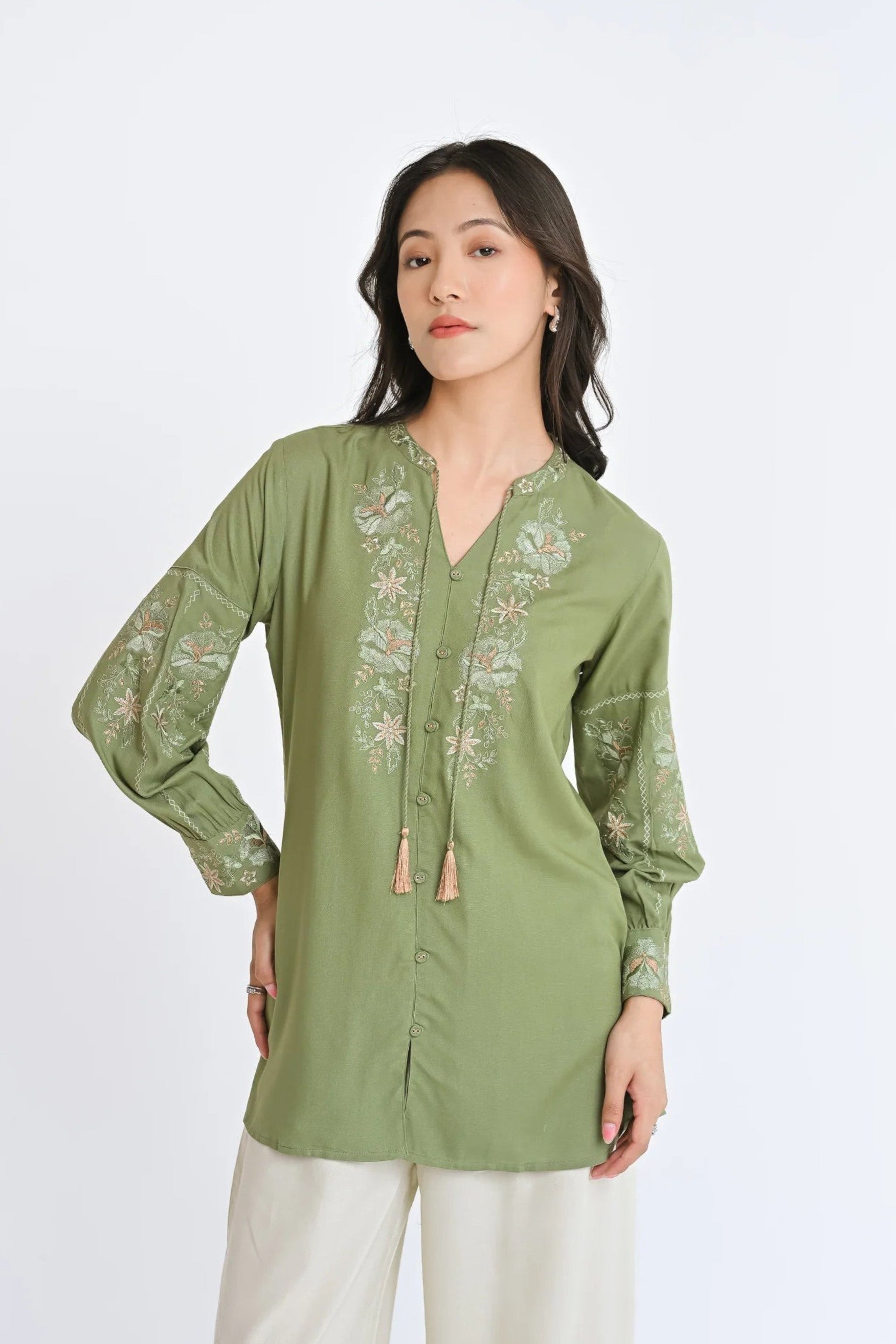 indigrey sage Ivy shirt featuring Fly Brick stitch floral embroidery on neckline and sleeves with tassel hem details