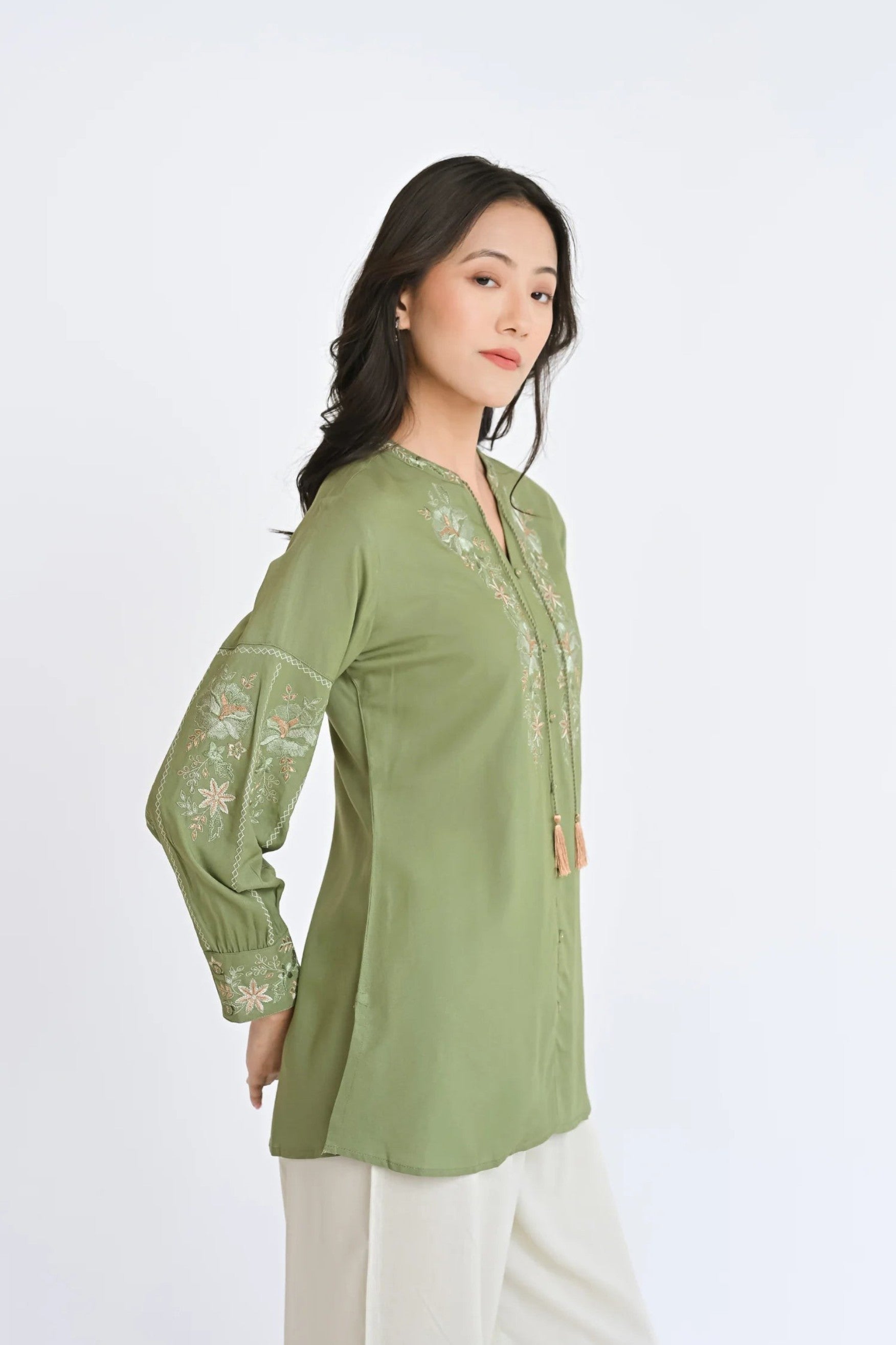 indigrey sage Ivy shirt featuring Fly Brick stitch floral embroidery on neckline and sleeves with tassel hem details
