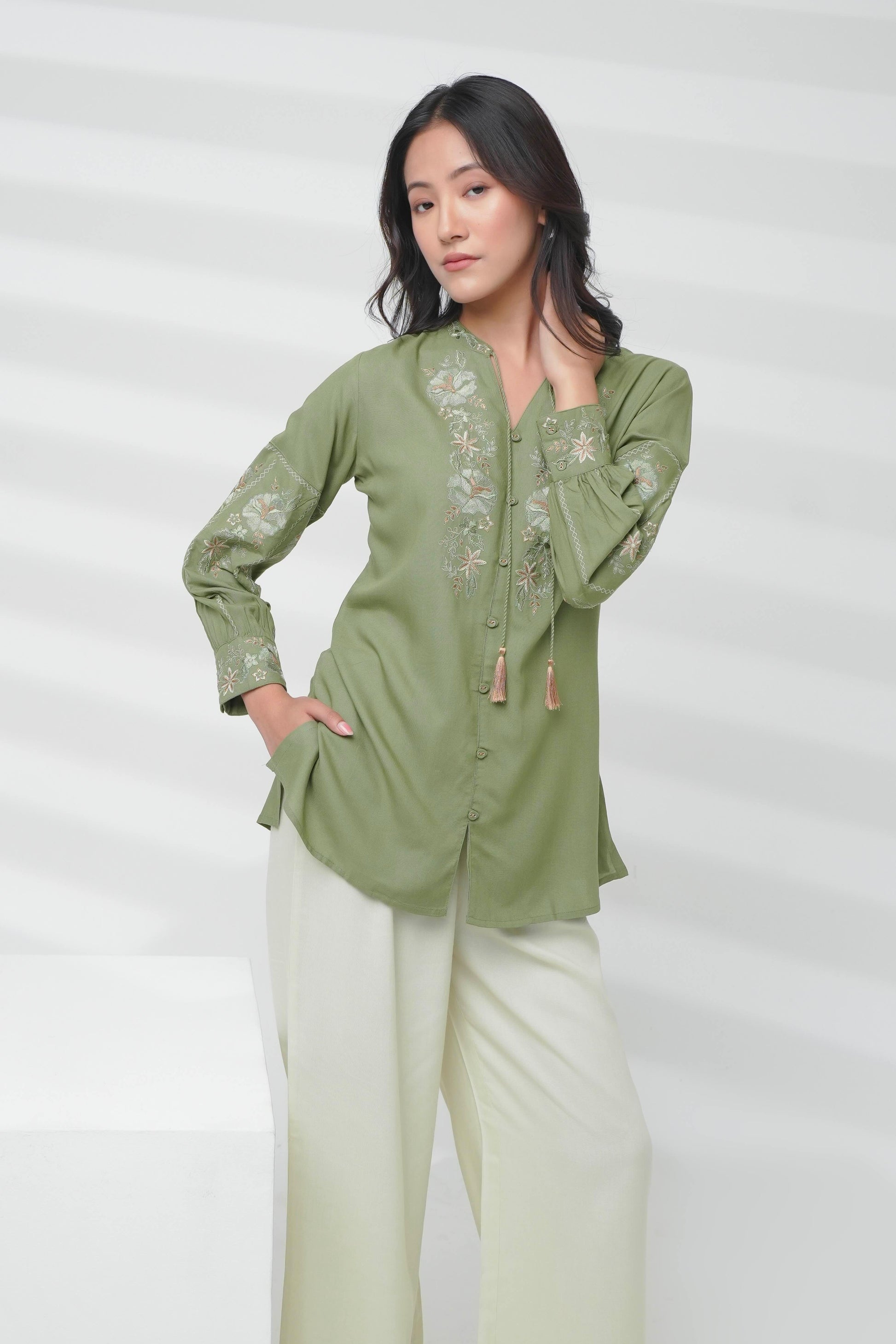 indigrey sage Ivy shirt featuring Fly Brick stitch floral embroidery on neckline and sleeves with tassel hem details.