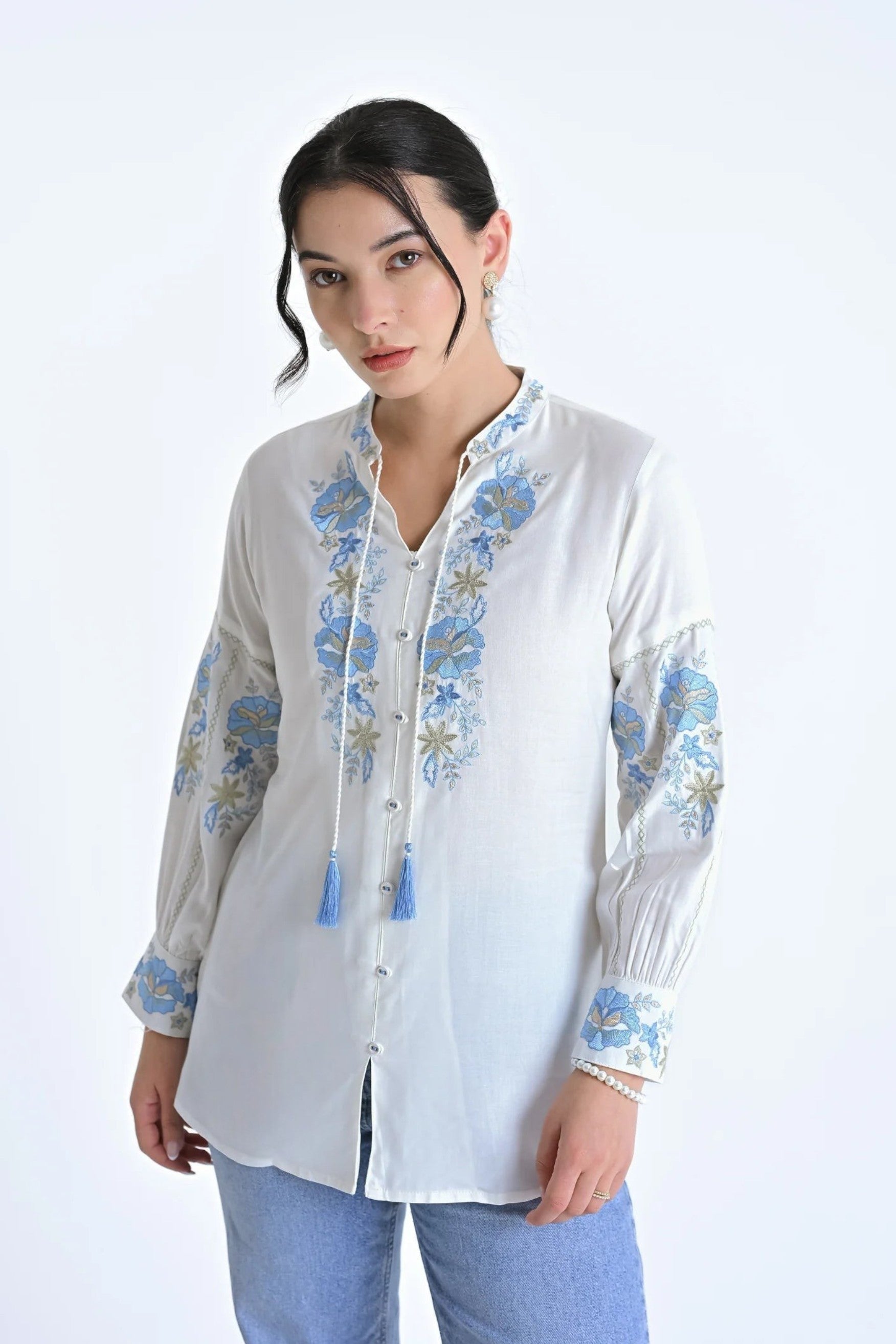 indigrey white shirt with blue floral fly brick stitch embroidery, tassel neck ties, and long sleeves on a model