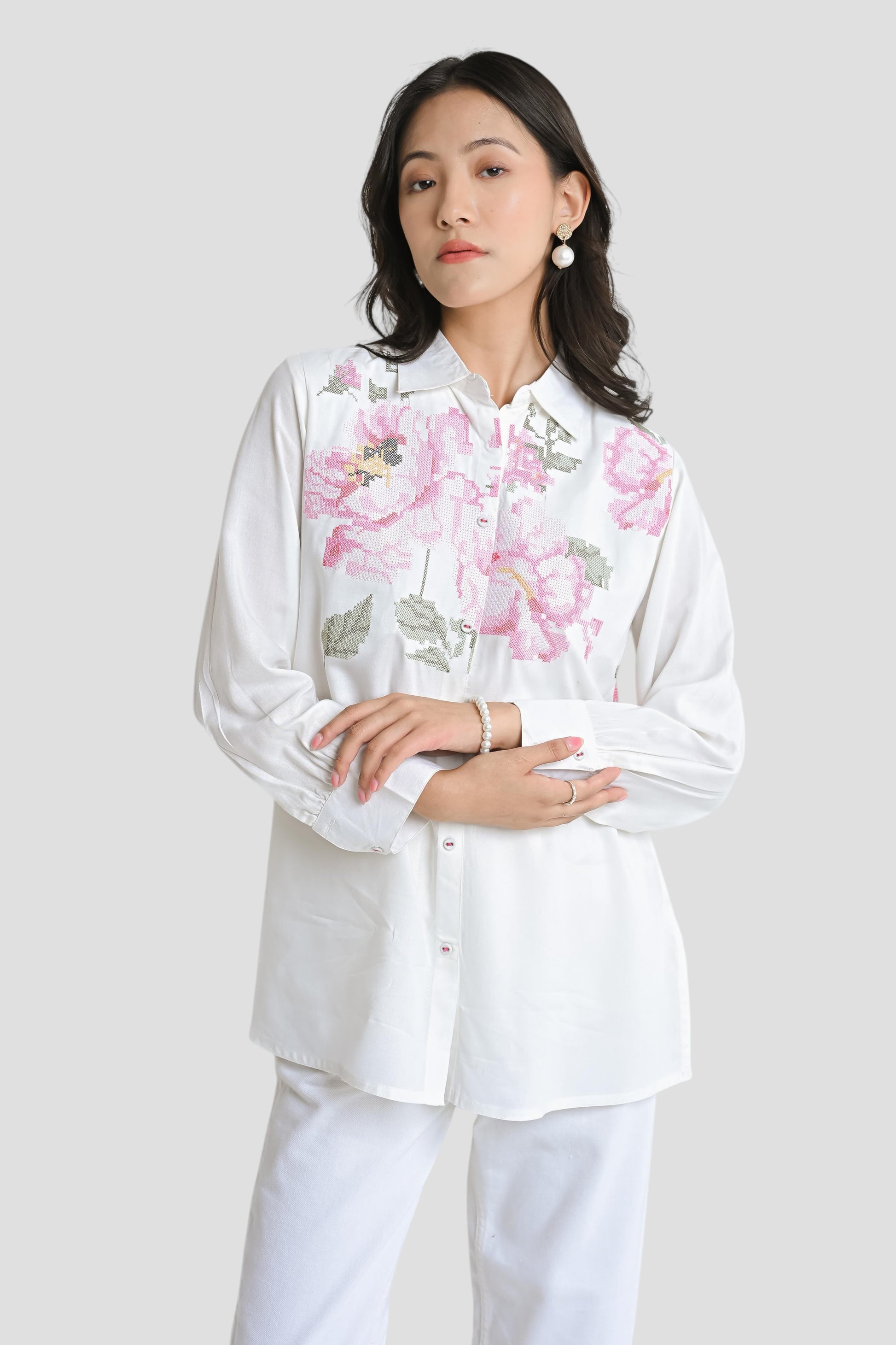 indigrey white shirt featuring pink and green floral pixel cross stitch embroidery on a woman