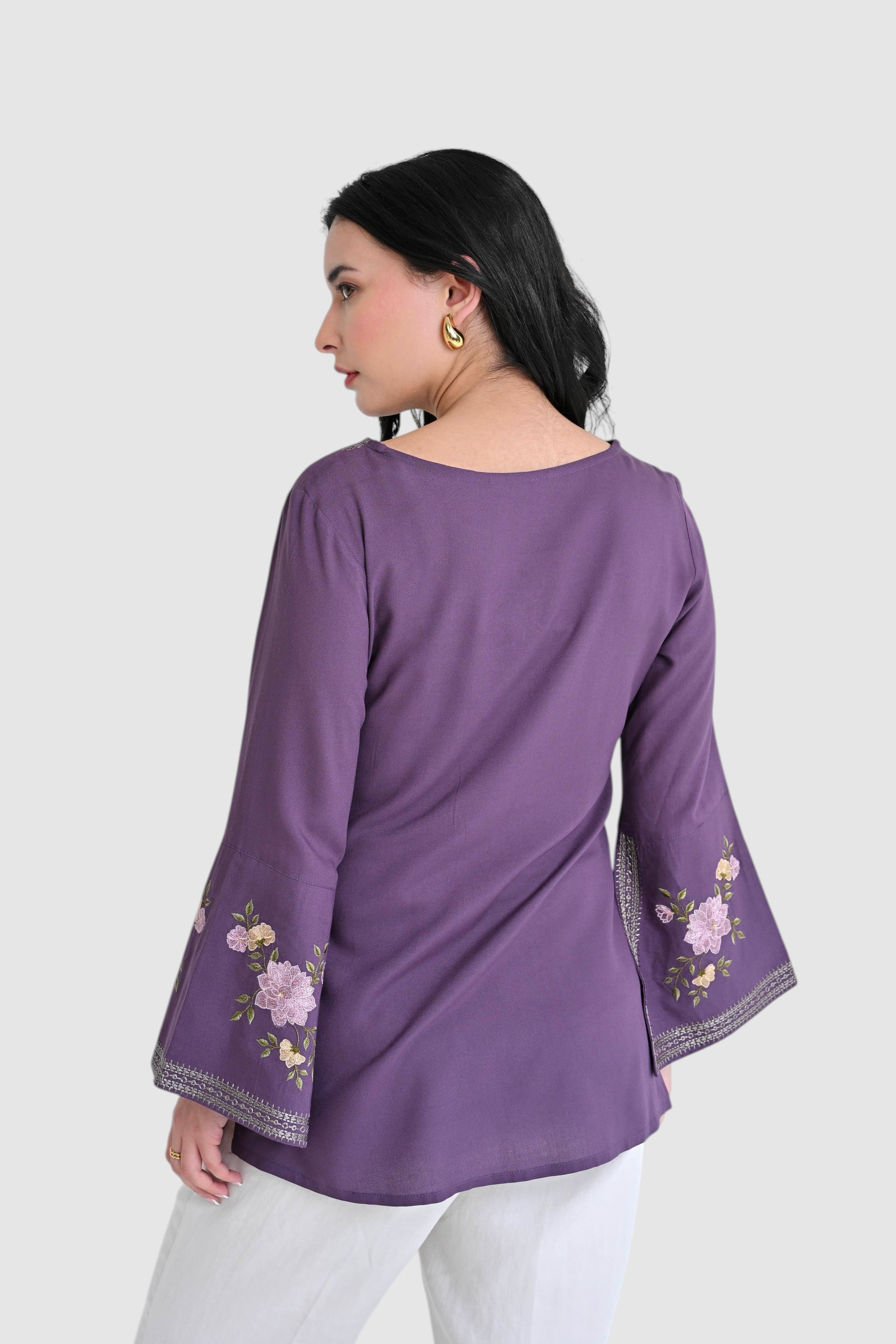 indigrey Zuri purple top with floral Sketchfill Cord embroidery and flared bell sleeves worn by a woman