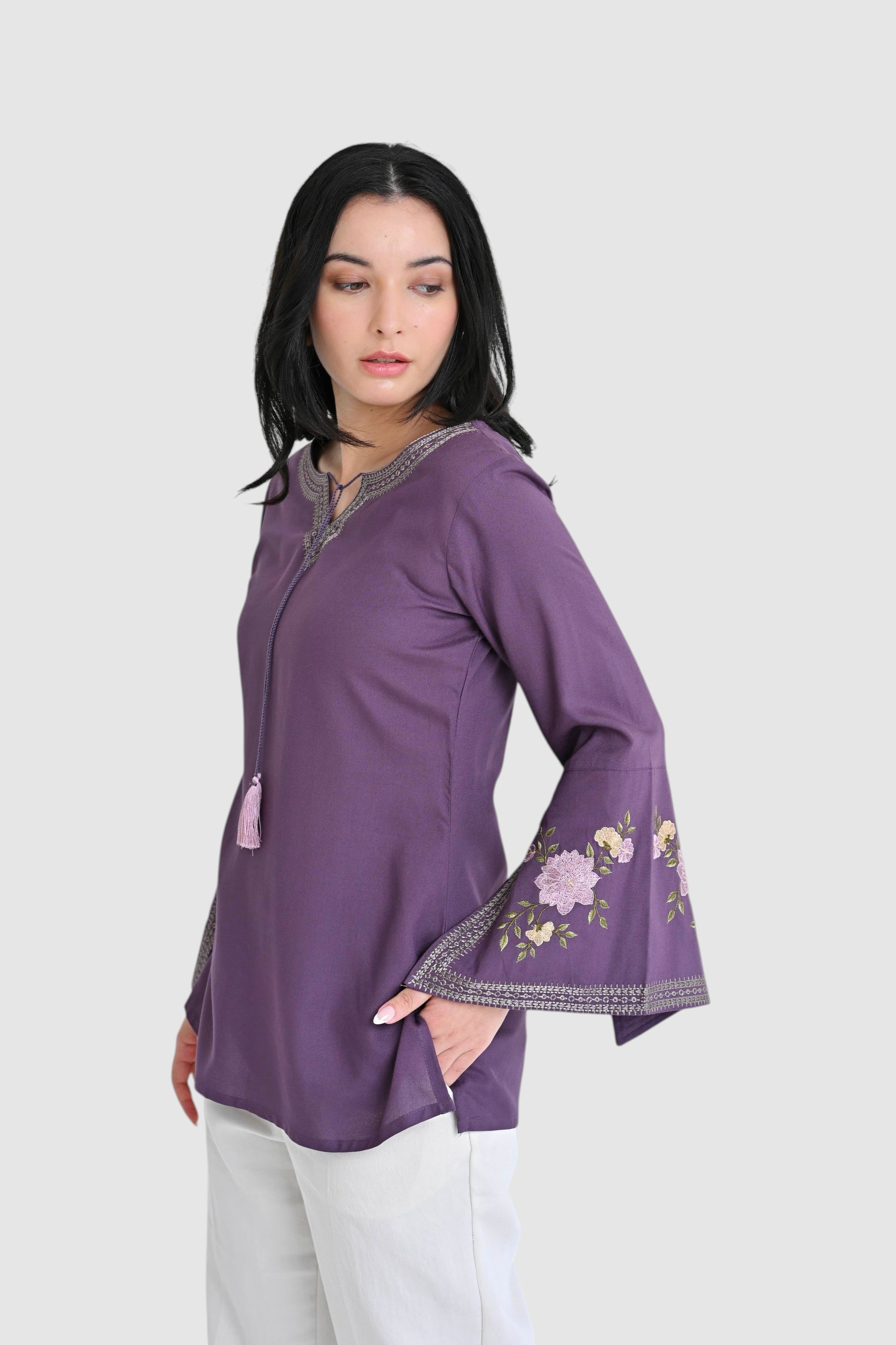 indigrey Zuri purple top with floral embroidery and flared bell sleeves worn by a model